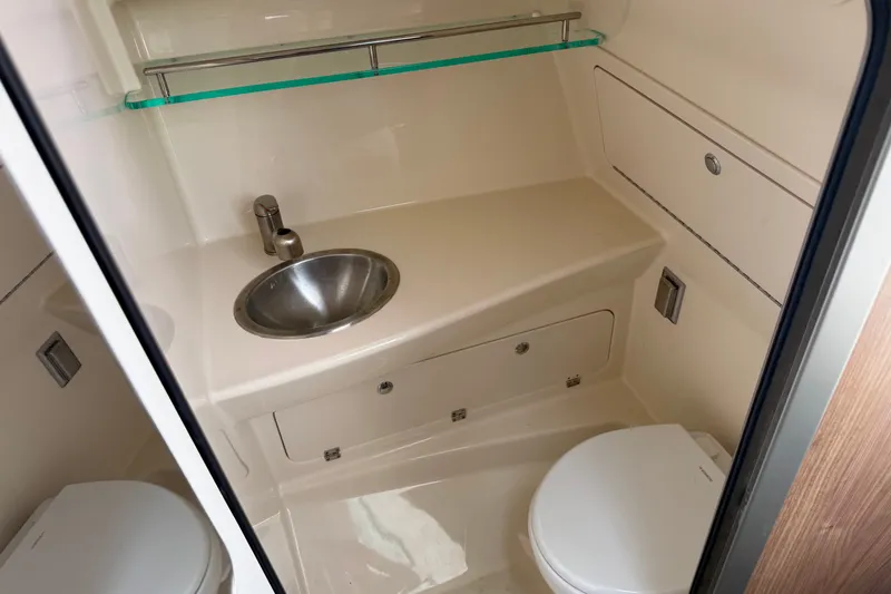 Slide: The Image of 2020 Boston Whaler 285 Conquest bathroom with sink, toilet, and storage. - 7