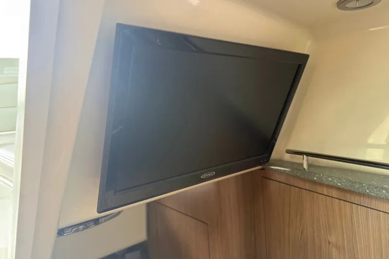 Slide: The Image of Flat-screen TV in 2020 Boston Whaler 285 Conquest cabin interior. - 12