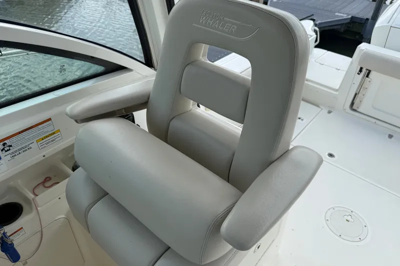 Slide: The Image of Captain's chair on 2020 Boston Whaler 285 Conquest boat, featuring sleek design and comfort. - 5