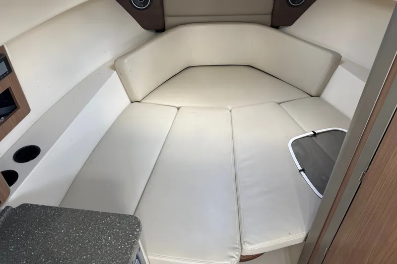 Slide: The Image of Interior cabin of 2020 Boston Whaler 285 Conquest with cushioned seating and storage. - 11