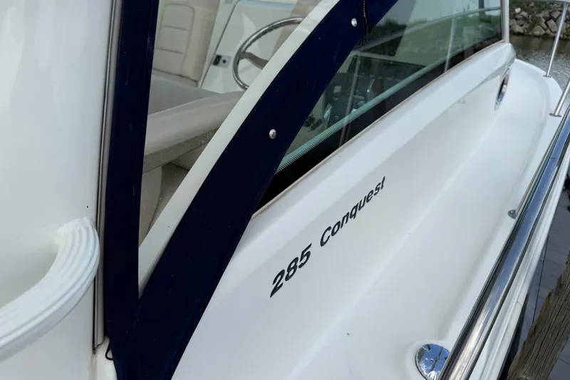 Slide: The Image of 2020 Boston Whaler 285 Conquest boat side view with model name visible. - 3