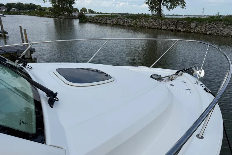 Slide: The Image of 2020 Boston Whaler 285 Conquest boat deck on calm waterway. - 6