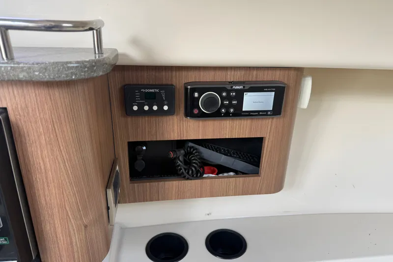 Slide: The Image of Control panel on 2020 Boston Whaler 285 Conquest boat with audio system and storage. - 10