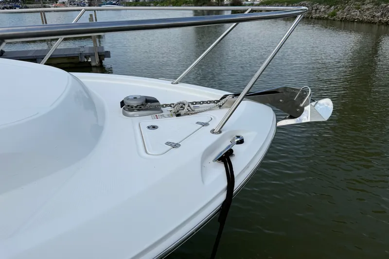 Slide: The Image of 2020 Boston Whaler 285 Conquest bow with anchor, docked on calm water. - 4