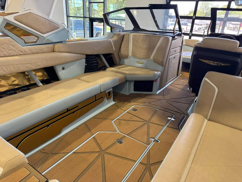 Slide: The Image of The image shows the luxurious interior of a Nautique Super Air Nautique G25 Paragon boat with beige upholstery. - 18