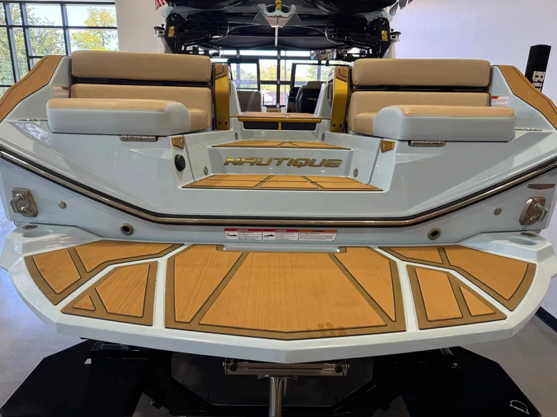 Slide: The Image of The image shows the stern of a 2026 Nautique Super Air Nautique G25 Paragon with sleek wood accents. - 9