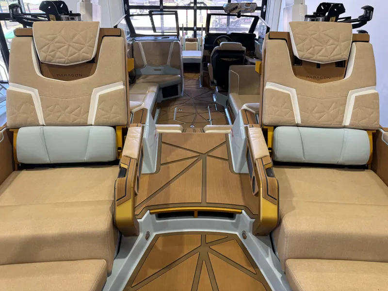 Slide: The Image of The image shows the luxurious interior of a Nautique Super Air Nautique G25 Paragon with elegant seating and modern design. - 14