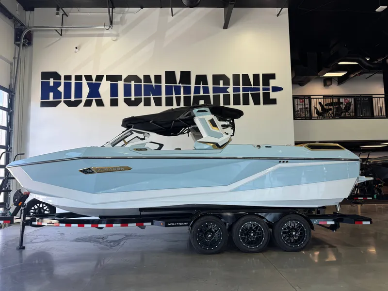 Slide: The Image of A sleek, light blue boat on a trailer in a showroom. It features a modern design. - 4