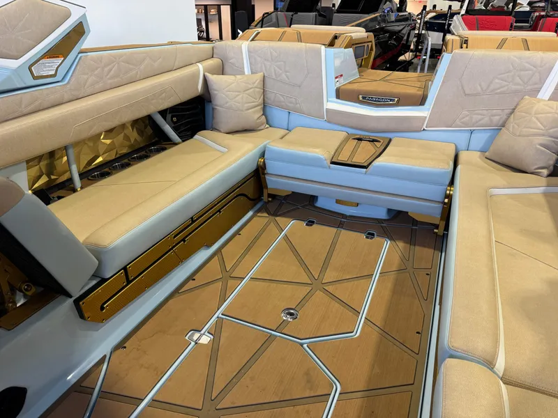 Slide: The Image of Luxurious interior of a 2026 Nautique Super Air Nautique G25 Paragon with beige upholstery and geometric flooring. - 19