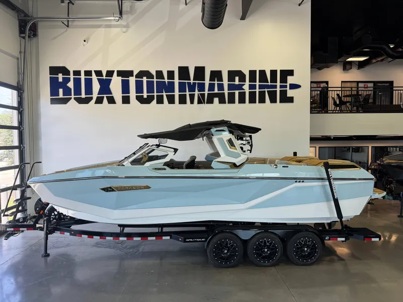 Slide: The Image of A sleek, modern boat with a blue hull is displayed in a showroom. - 5