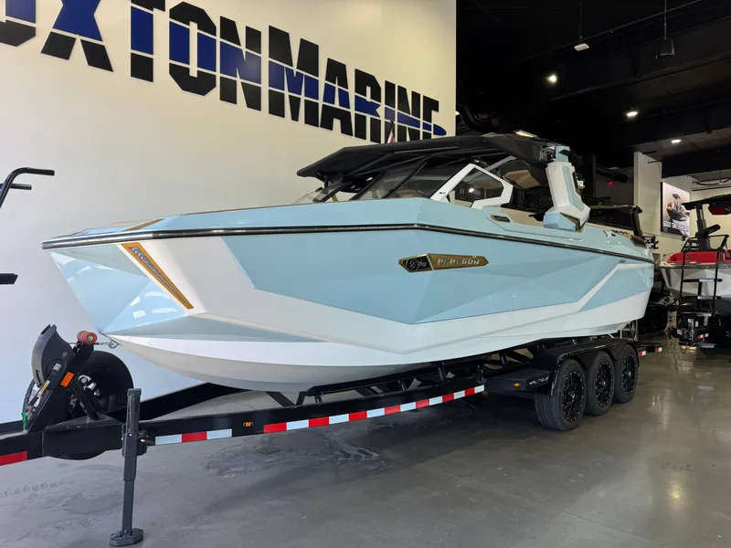 Slide: The Image of A sleek, modern boat with a blue hull sits on a trailer in a showroom. - 2