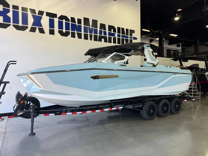 Slide: The Image of A 2026 Super Air Nautique G25 Paragon on a trailer in a showroom. - 3