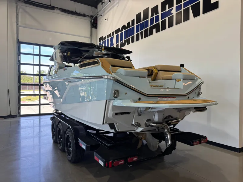 Slide: The Image of A luxury motorboat on a trailer in a showroom. It features sleek design and modern amenities. - 6