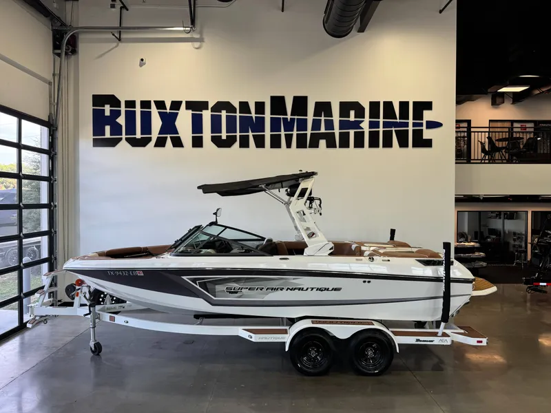 The Image of A 2018 Super Air Nautique GS22 on a trailer in a showroom. - 1