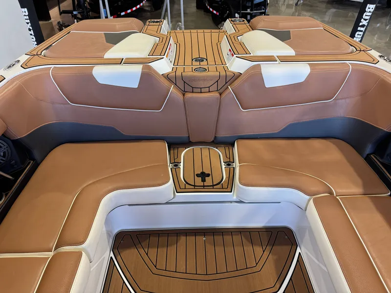 Slide: The Image of The image shows the luxurious interior of a 2018 Nautique Super Air Nautique GS22 with brown and white upholstery. - 27