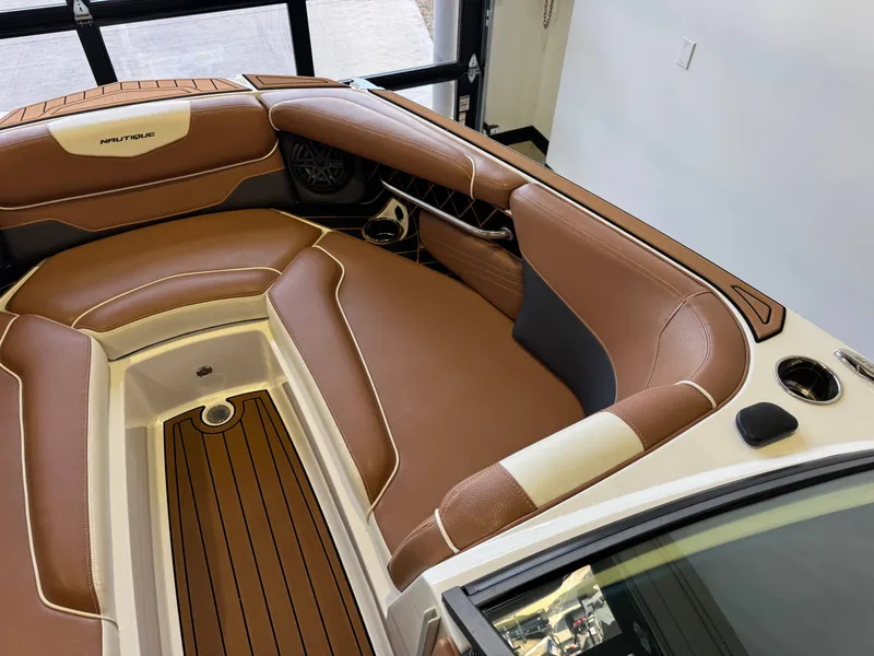 Slide: The Image of The image shows the interior of a 2018 Nautique Super Air Nautique GS22 with brown leather seating. - 18