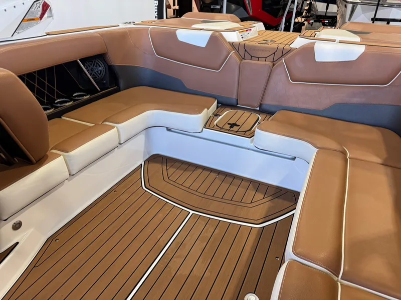 Slide: The Image of The image shows the interior of a 2018 Nautique Super Air Nautique GS22 with brown and white seating. - 15