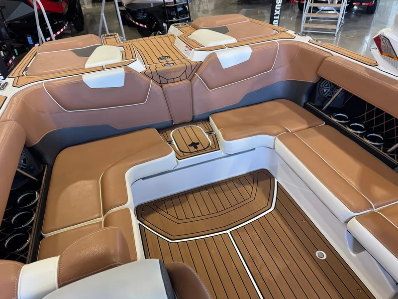 Slide: The Image of The image shows the interior of a 2018 Nautique Super Air Nautique GS22 with brown and white seating. - 16