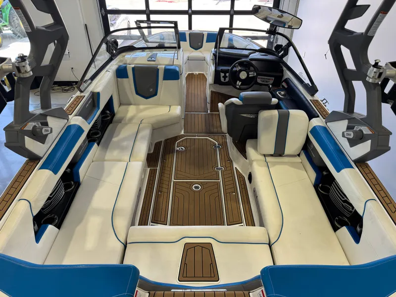 Slide: The Image of Interior of a 2020 Nautique Super Air Nautique G23 with blue and white seating. - 13
