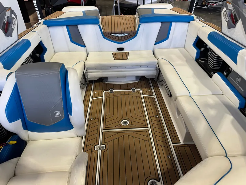 Slide: The Image of Interior of a 2020 Nautique Super Air Nautique G23 with white and blue seating and wood flooring. - 22
