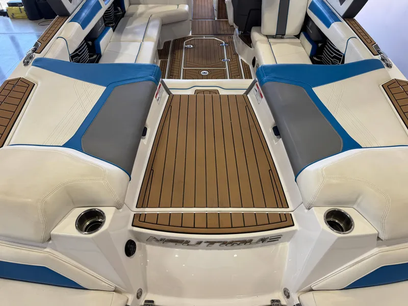 Slide: The Image of The image shows the stern of a 2020 Nautique Super Air Nautique G23 with luxurious seating. - 10