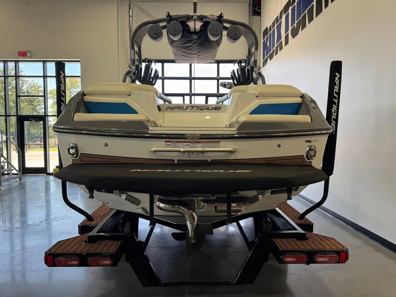 Slide: The Image of The image shows the rear of a 2020 Super Air Nautique G23 boat in a showroom. - 6