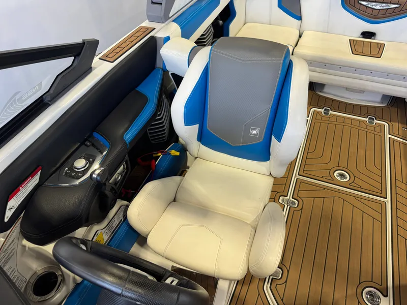 Slide: The Image of The image shows the interior of a 2020 Nautique Super Air Nautique G23 with blue and white seating. - 21