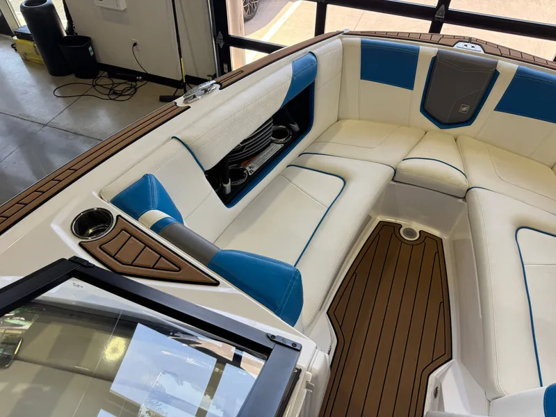 Slide: The Image of The image shows the interior of a 2020 Nautique Super Air Nautique G23 with white and blue seating. - 19