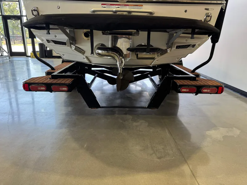 Slide: The Image of The stern of a 2020 Nautique Super Air Nautique G23 with dual exhaust and wooden platforms. - 7