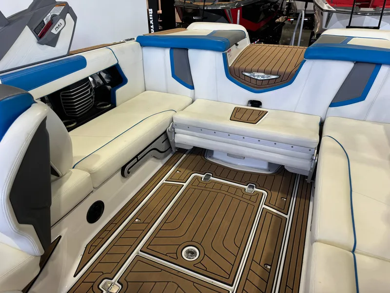 Slide: The Image of The image shows the interior of a 2020 Nautique Super Air Nautique G23 with white and blue seating. - 15