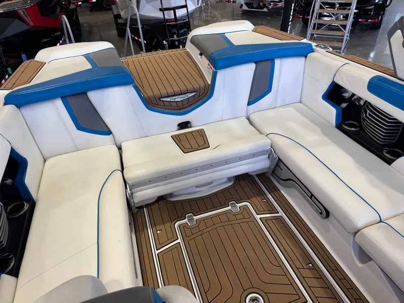 Slide: The Image of The image shows the cockpit of a 2020 Nautique Super Air Nautique G23 with white and blue seating. - 16