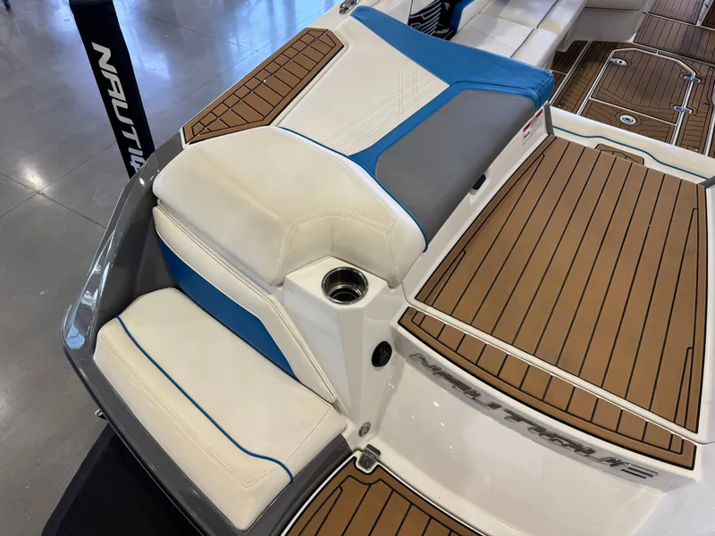 Slide: The Image of The image shows the stern of a 2020 Super Air Nautique G23 with cushioned seats and teak-style decking. - 12