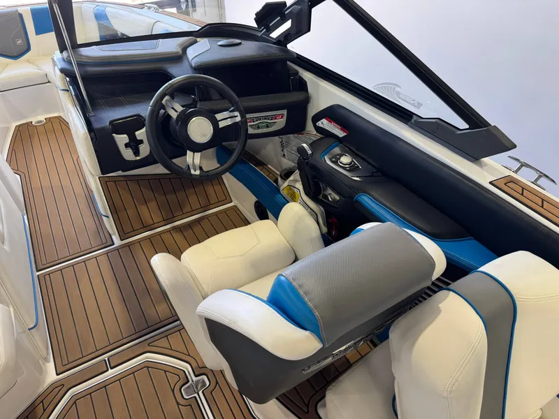 Slide: The Image of The image shows the cockpit of a 2020 Nautique Super Air Nautique G23 with modern controls and luxurious seating. - 25