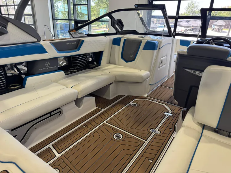 Slide: The Image of The image shows the interior of a 2020 Super Air Nautique G23 with white and blue seating. - 14