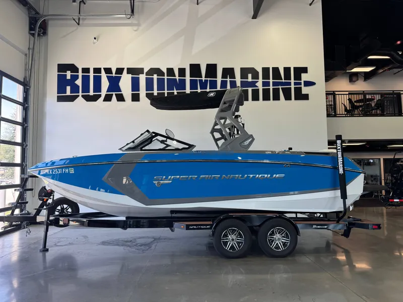 Slide: The Image of A blue and white 2020 Nautique Super Air Nautique G23 on a trailer in a showroom. - 4