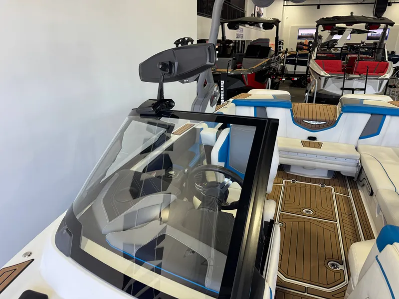 Slide: The Image of The image shows the cockpit of a 2020 Nautique Super Air Nautique G23 with blue and white seats. - 20