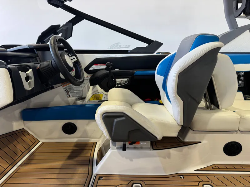 Slide: The Image of The image shows the cockpit of a 2020 Nautique Super Air Nautique G23 with modern seating and wood accents. - 23