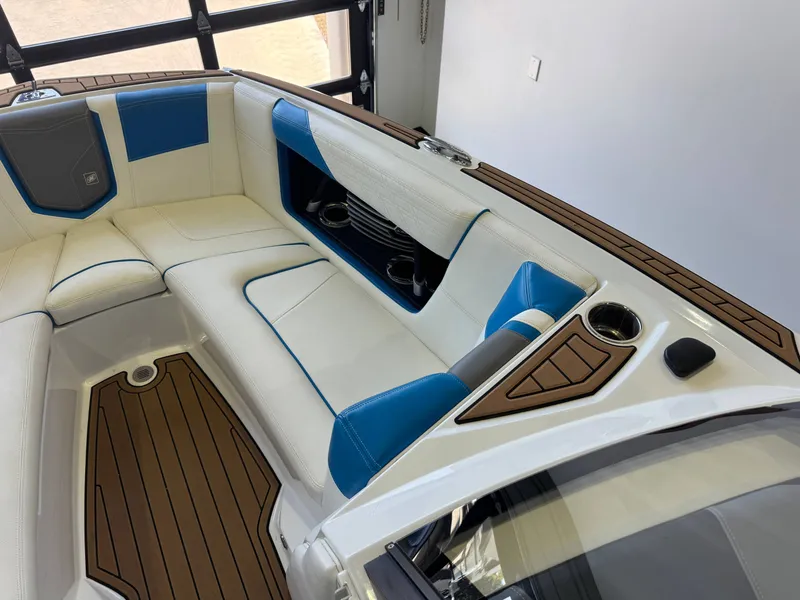 Slide: The Image of The image shows the interior of a 2020 Nautique Super Air Nautique G23 with white and blue seating. - 18