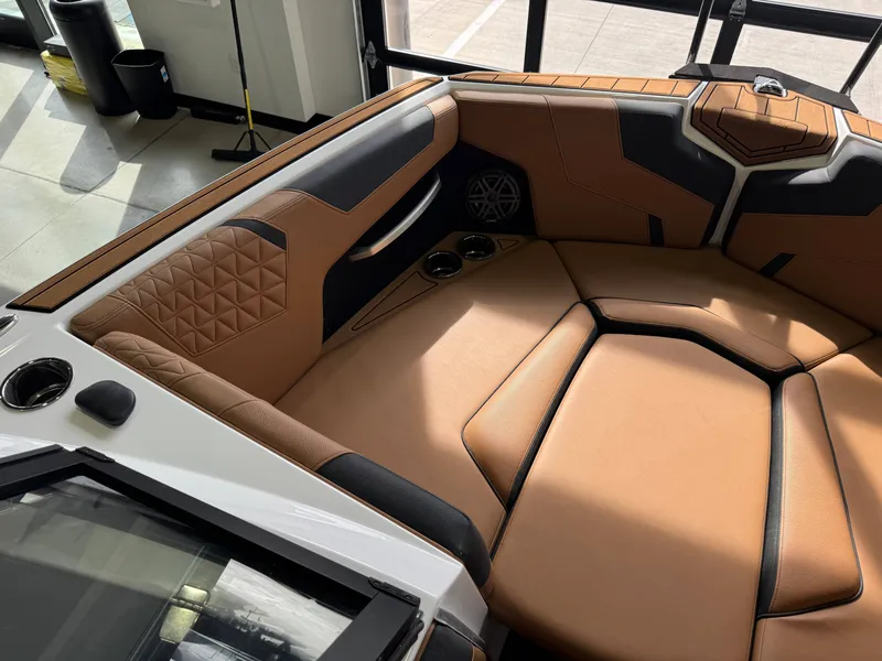 Slide: The Image of The image shows the interior of a 2026 Nautique Super Air Nautique GS22 with sleek brown upholstery. - 19