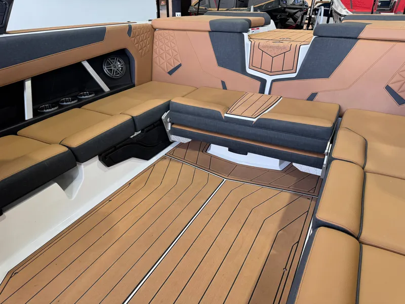 Slide: The Image of The image shows the interior of a 2026 Nautique Super Air Nautique GS22 with sleek, cushioned seating and stylish flooring. - 15