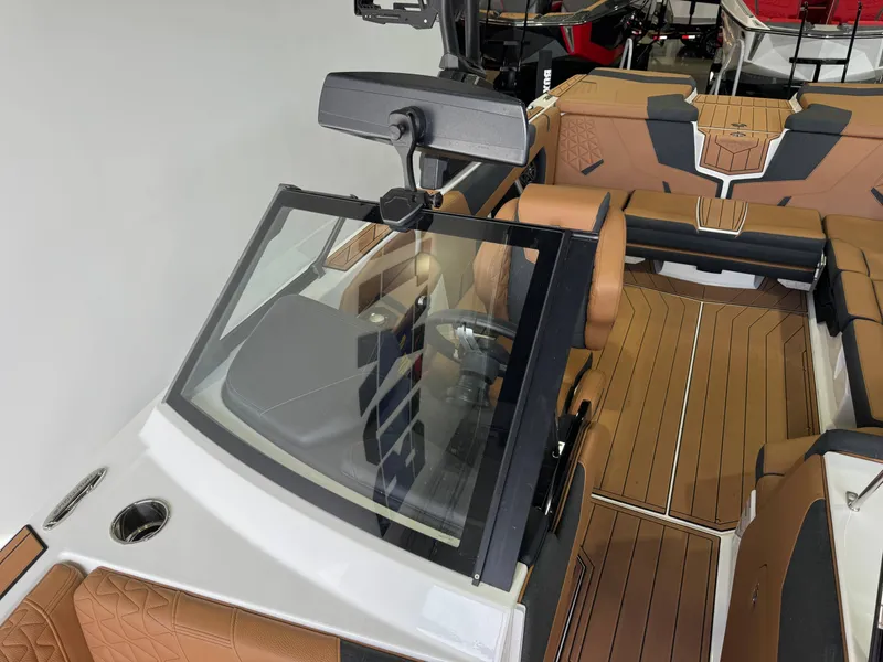 Slide: The Image of The image shows the cockpit of a 2026 Nautique Super Air Nautique GS22 with brown seats and wood flooring. - 20