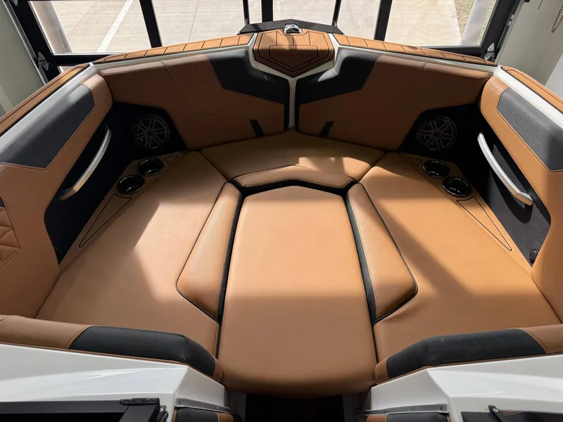 Slide: The Image of The image shows the interior of a 2026 Nautique Super Air Nautique GS22 with brown leather seating. - 17