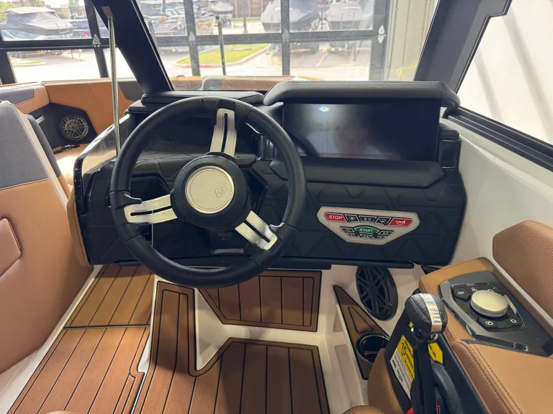 Slide: The Image of The image shows the cockpit of a 2026 Nautique Super Air Nautique GS22 with a modern steering wheel and large display. - 26