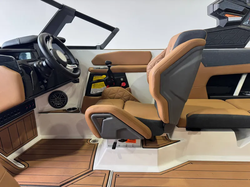 Slide: The Image of The image shows the interior of a 2026 Nautique Super Air Nautique GS22 with brown leather seats. - 23