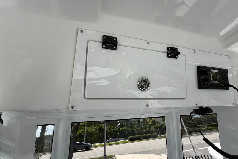 Slide: The Image of 2026 Sea Pro 245FLXR Sandbar boat interior with storage compartment and Simrad electronics. - 17