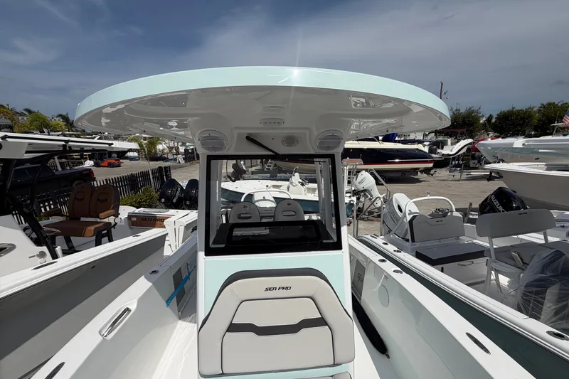 Slide: The Image of 2026 Sea Pro 245FLXR Sandbar boat with sleek design, showcased in a marina setting. - 22