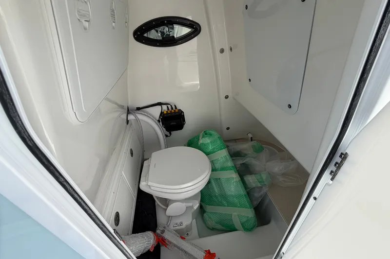 Slide: The Image of Interior of 2026 Sea Pro 245FLXR Sandbar boat with compact marine toilet. - 29