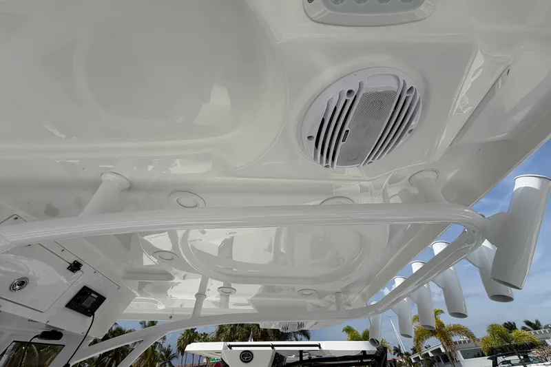 Slide: The Image of 2026 Sea Pro 245FLXR Sandbar boat interior with speaker and rod holders. - 24