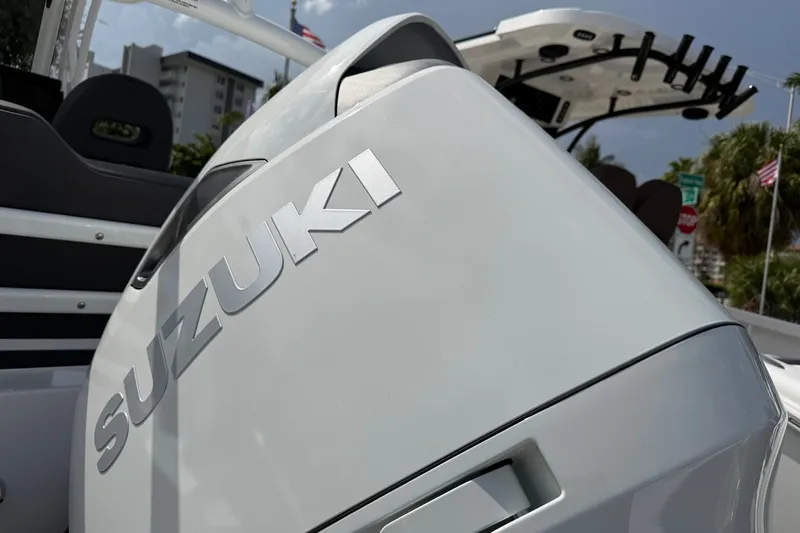 Slide: The Image of Suzuki engine on 2026 Sea Pro 245FLXR Sandbar boat, outdoor setting. - 36