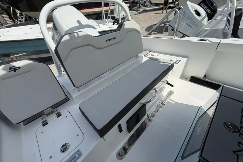 Slide: The Image of 2026 Sea Pro 245FLXR Sandbar boat interior with seating and storage compartments. - 19